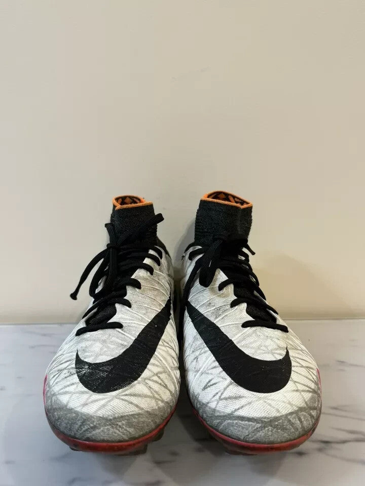 6973877